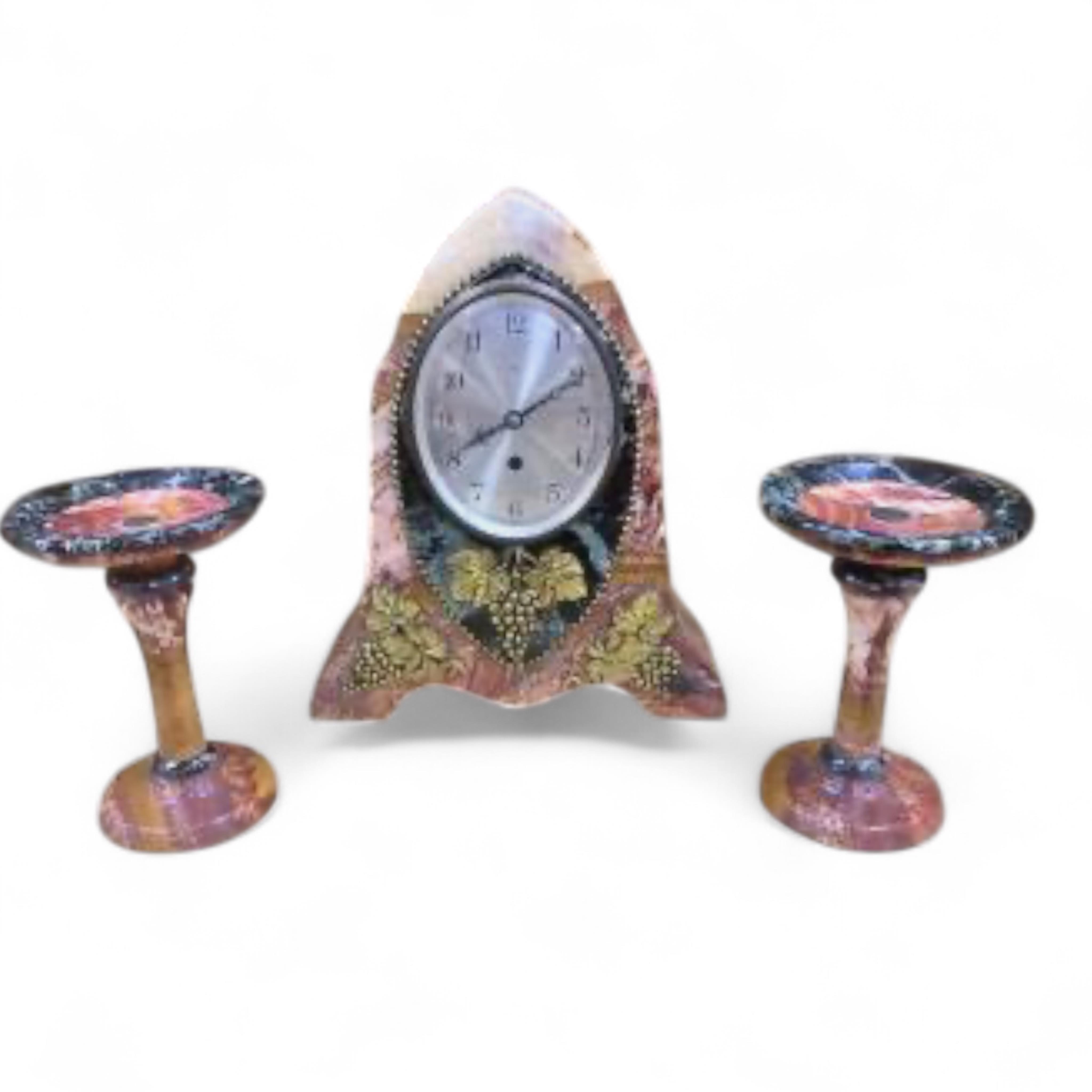 An early 20th century French rouge and black marble clock garniture with ornamental grape motif mounts to the clock and with a key, clock 34.5cm high